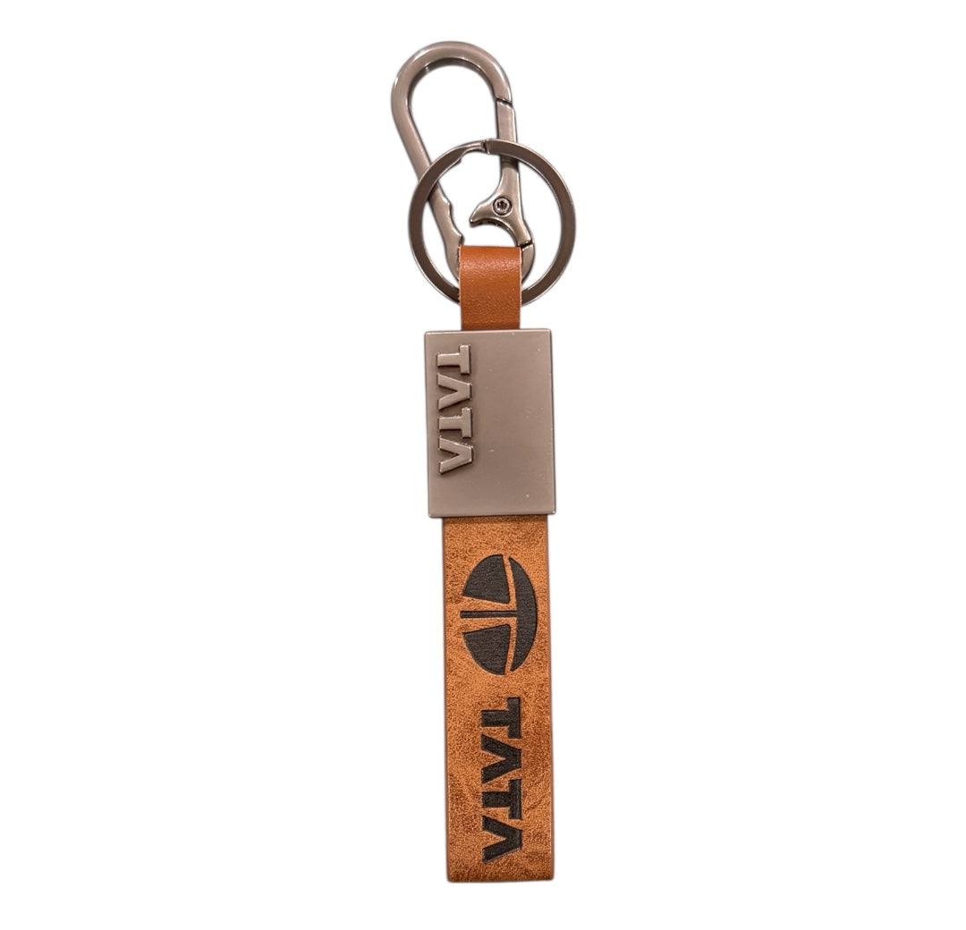 Wooden keychain with metal clip and 'TATA' branding on a white background