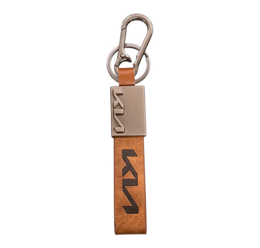Kia Keychain with brown strap and metal clip on a white background